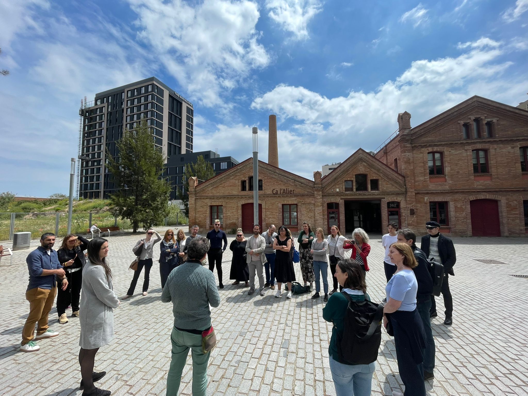 Training group standing in a circle outside as part of the site visit to discuss the Equal-Life findings in practice