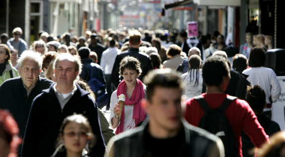 Busy street with people walking towards the camera