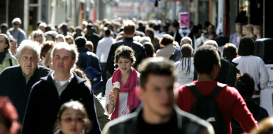 Busy street with people walking towards the camera